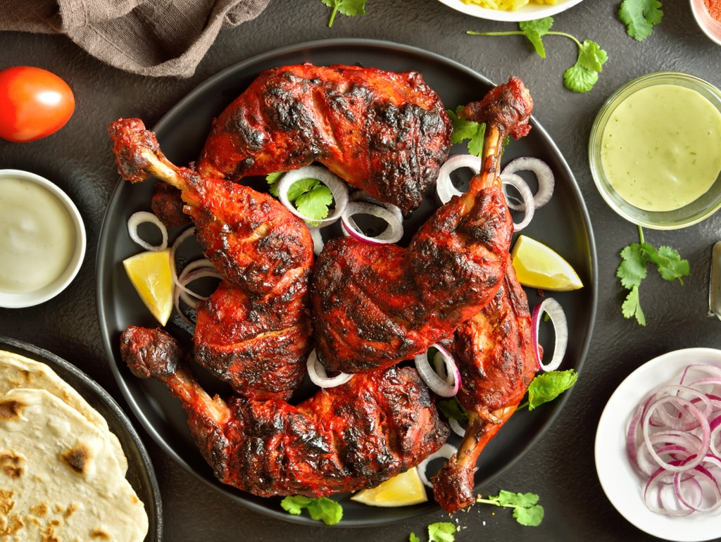 Grilled chicken legs with onions and lemons.