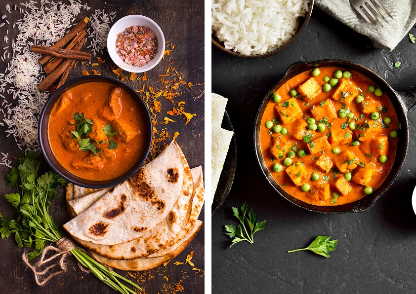 Indian curry dishes with naan and rice.