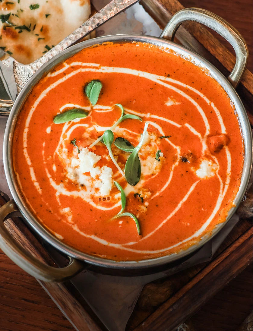 Creamy tomato curry with naan bread.