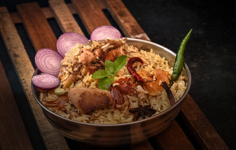 Chicken biryani with onions and green chili.